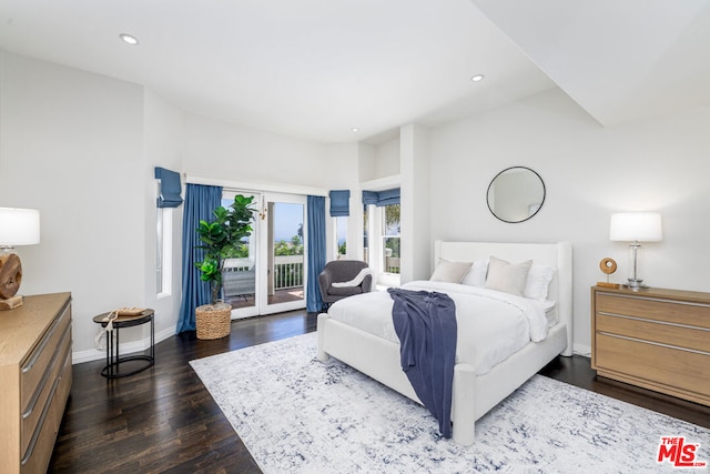 bedroom featuring access to exterior and dark hardwood / wood-style flooring