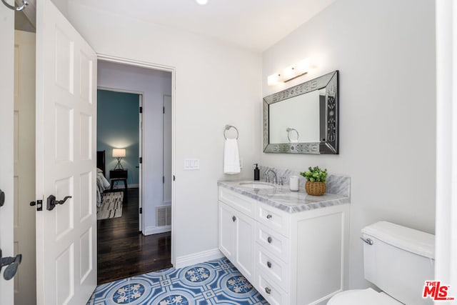 bathroom featuring vanity and toilet