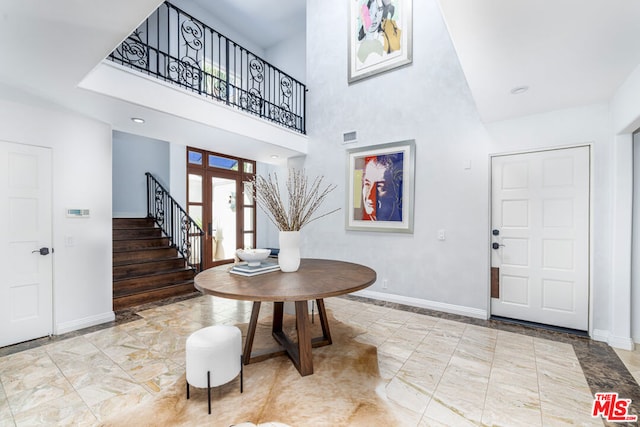 foyer entrance with a towering ceiling