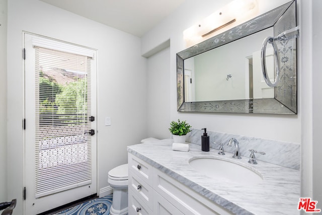 bathroom with vanity and toilet