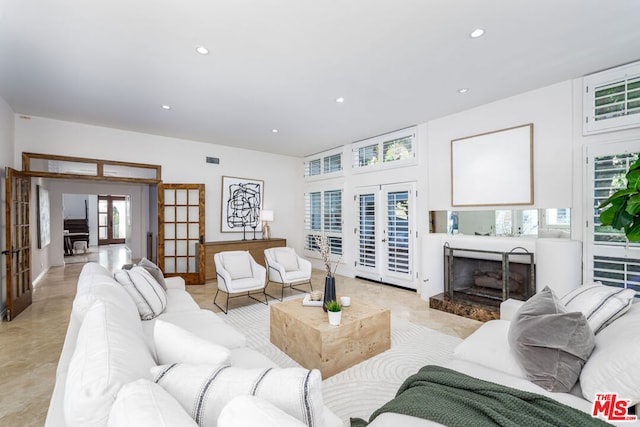 living room with a fireplace and french doors