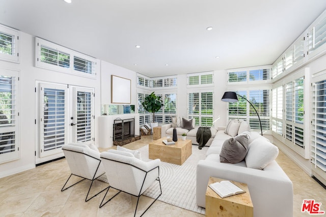 living room featuring a fireplace and french doors