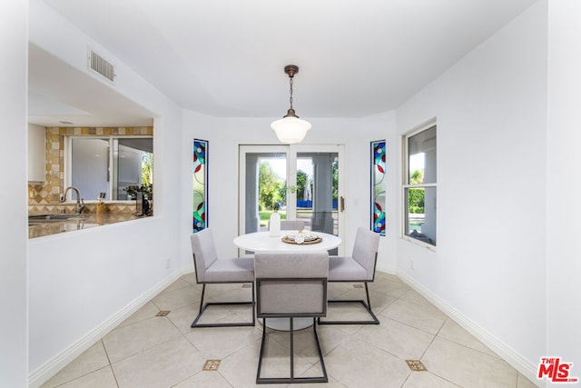 tiled dining room with sink