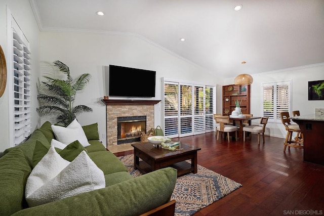 living room with lofted ceiling, a wealth of natural light, ornamental molding, and dark hardwood / wood-style floors