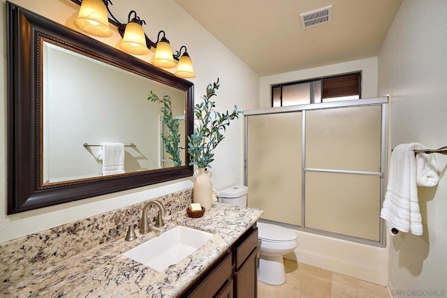 full bathroom featuring vanity, bath / shower combo with glass door, and toilet