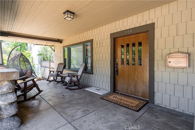 doorway to property with covered porch