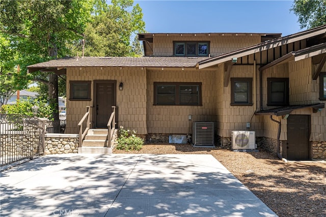 view of front of property featuring a patio, ac unit, and cooling unit