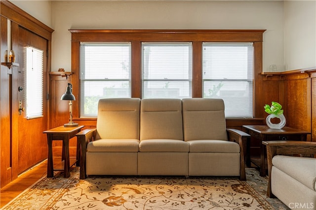 living room featuring wooden walls and light wood-type flooring