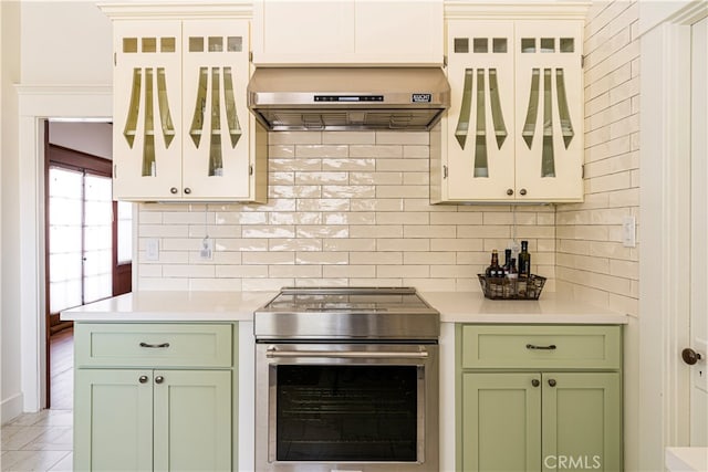 kitchen with white cabinetry, decorative backsplash, ventilation hood, and stainless steel electric range oven