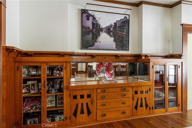 bar featuring hardwood / wood-style flooring and crown molding