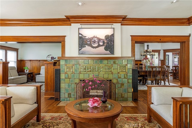 living room with hardwood / wood-style flooring and ornamental molding