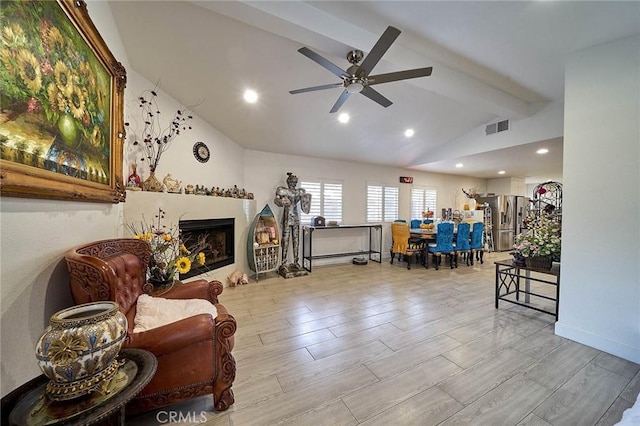 living room featuring lofted ceiling with beams and ceiling fan