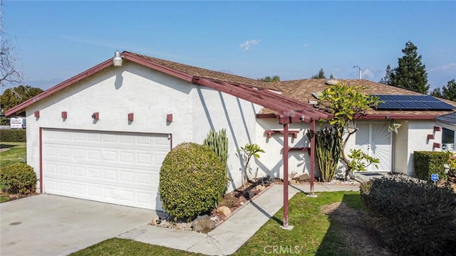 view of front of home with a garage and solar panels