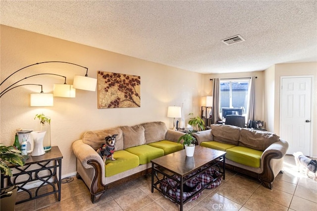 living room featuring tile patterned flooring and a textured ceiling