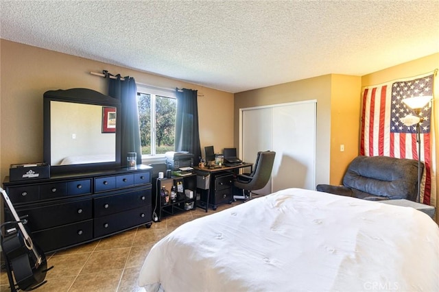 bedroom with a closet and a textured ceiling