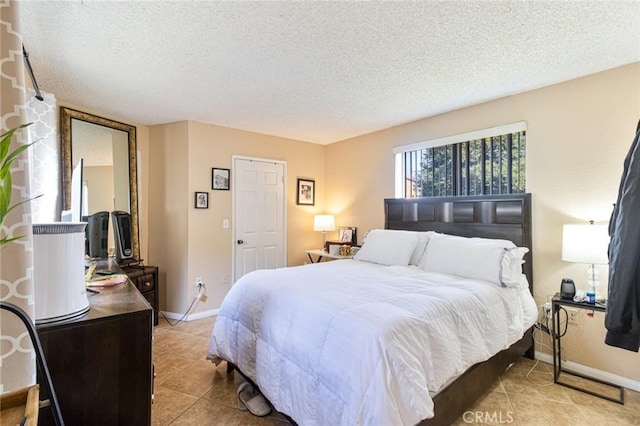 tiled bedroom featuring a textured ceiling