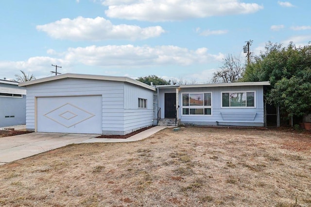 ranch-style home with a garage and a front lawn