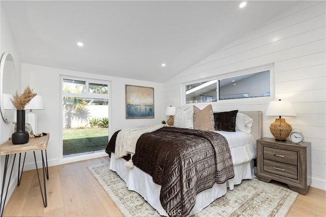 bedroom with vaulted ceiling and light hardwood / wood-style flooring