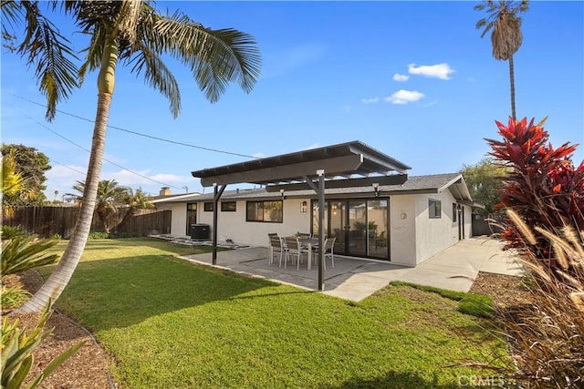 back of property featuring a lawn and a patio area