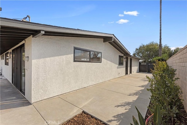 view of property exterior featuring a patio area