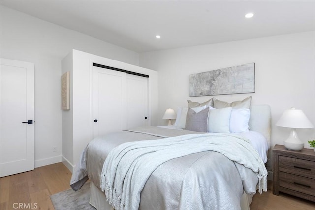 bedroom featuring light hardwood / wood-style floors and a closet