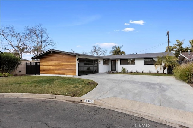 view of front of home featuring a garage and a front lawn