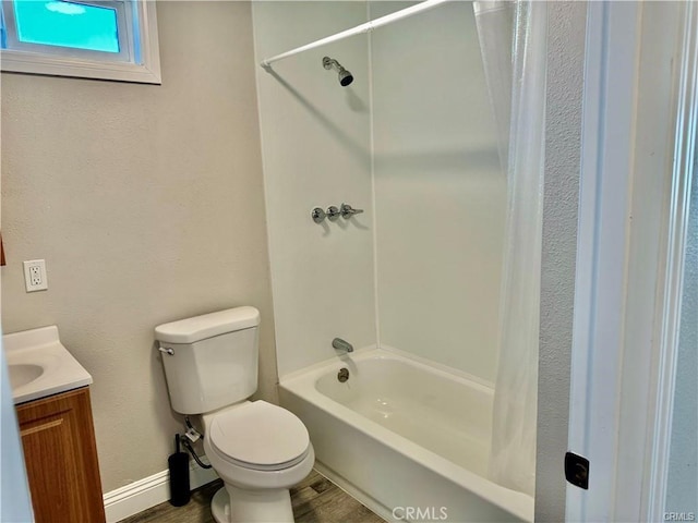 full bathroom featuring hardwood / wood-style flooring, shower / tub combo with curtain, vanity, and toilet