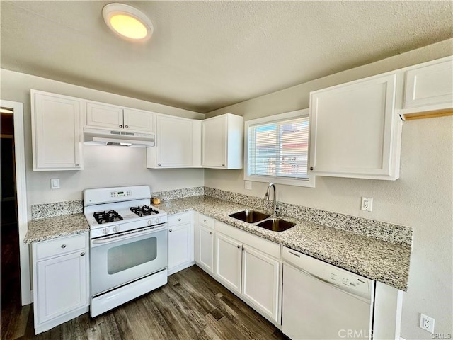 kitchen with white cabinetry, sink, light stone counters, dark wood-type flooring, and white appliances