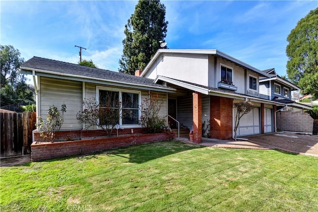 view of front of home with a front yard and a garage