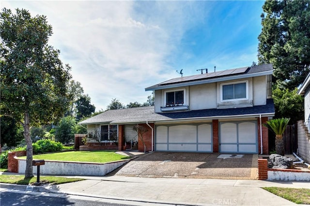 view of property with solar panels, a front yard, and a garage