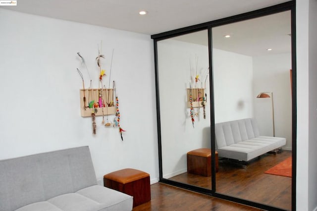 sitting room with dark hardwood / wood-style flooring