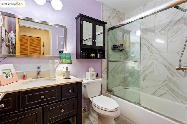 full bathroom featuring enclosed tub / shower combo, vanity, and toilet