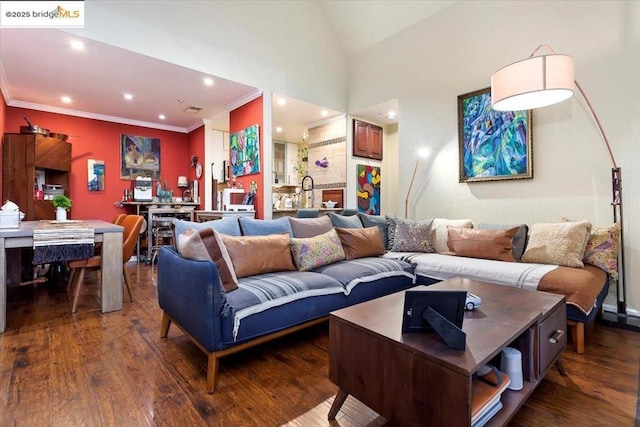 living room with vaulted ceiling, ornamental molding, and dark hardwood / wood-style flooring