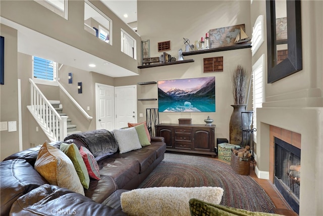 living room with a towering ceiling and a fireplace