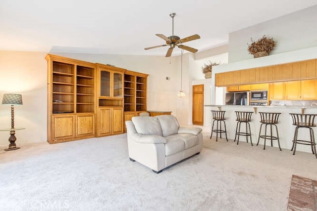 carpeted living room with lofted ceiling and ceiling fan