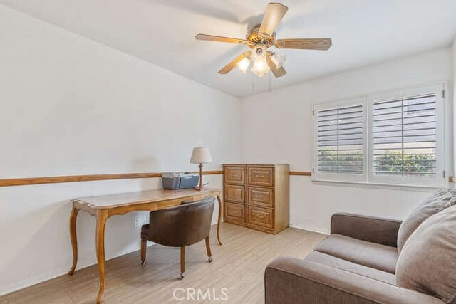 home office featuring light hardwood / wood-style floors and ceiling fan