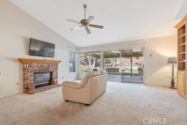 carpeted living room featuring ceiling fan, a fireplace, and vaulted ceiling