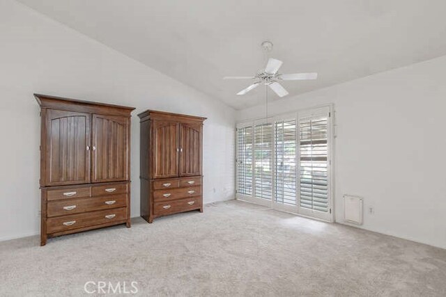 unfurnished bedroom with ceiling fan, lofted ceiling, light colored carpet, and access to outside