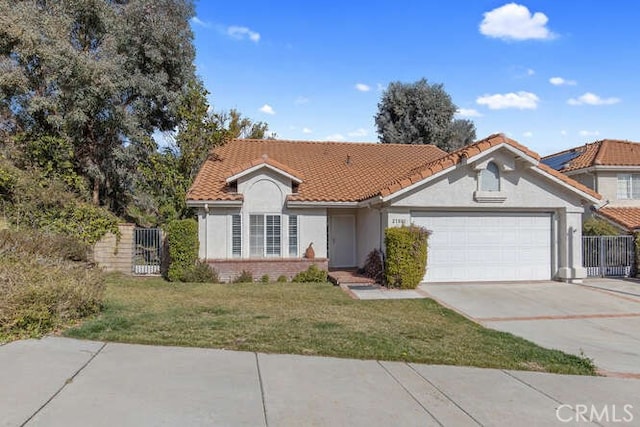 view of front of house featuring a garage and a front lawn