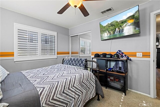 bedroom with ceiling fan and a closet