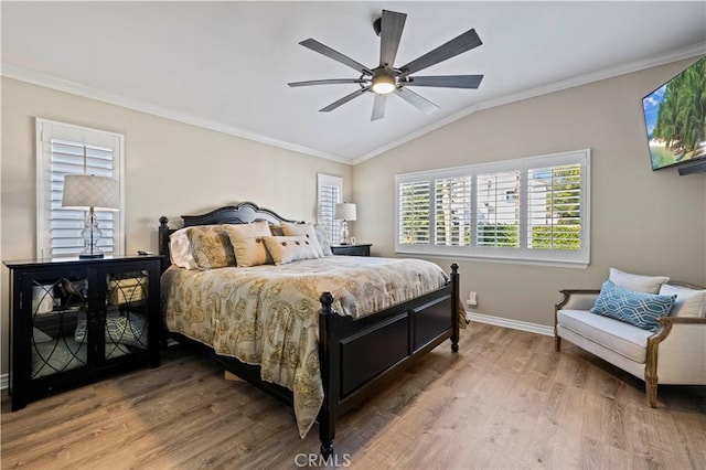 bedroom featuring crown molding, wood-type flooring, ceiling fan, and vaulted ceiling