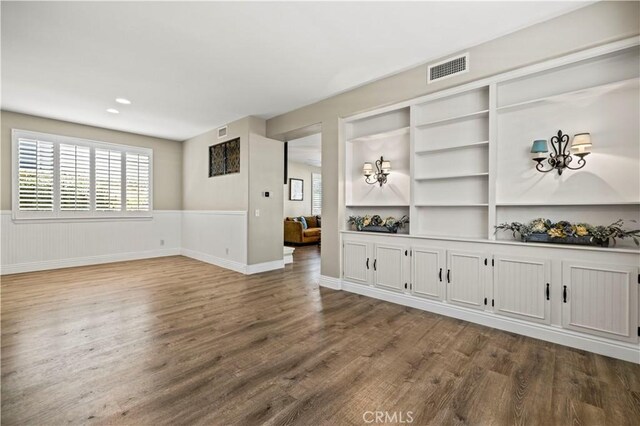 unfurnished living room featuring dark wood-type flooring