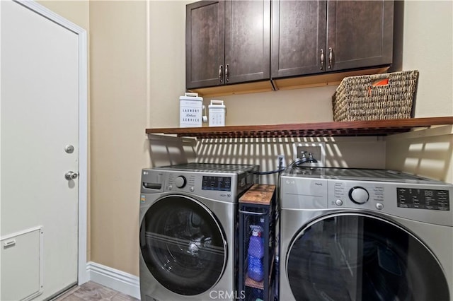 laundry area featuring cabinets and washing machine and dryer