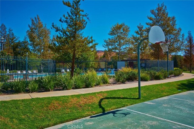 view of basketball court featuring a yard