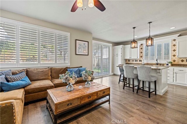 living room featuring hardwood / wood-style floors, a wealth of natural light, and ceiling fan