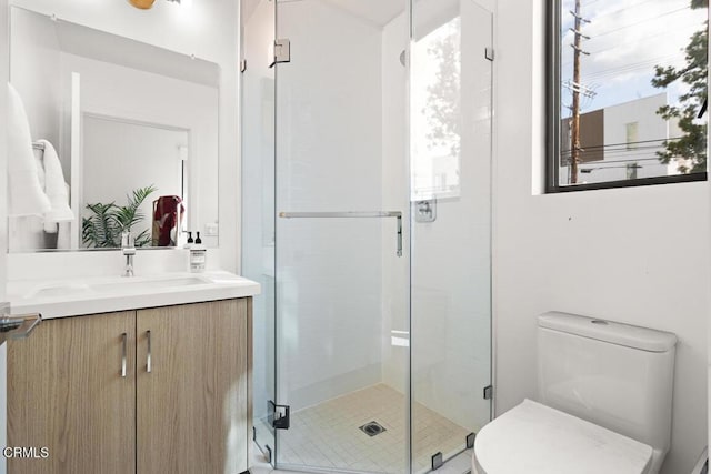 bathroom with vanity, toilet, and walk in shower