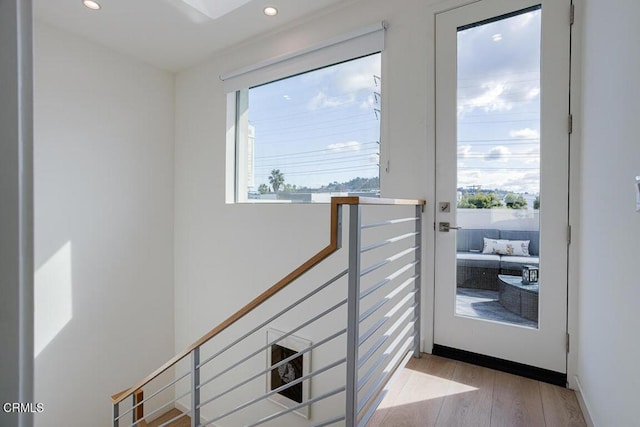 doorway to outside with light hardwood / wood-style floors and a wealth of natural light