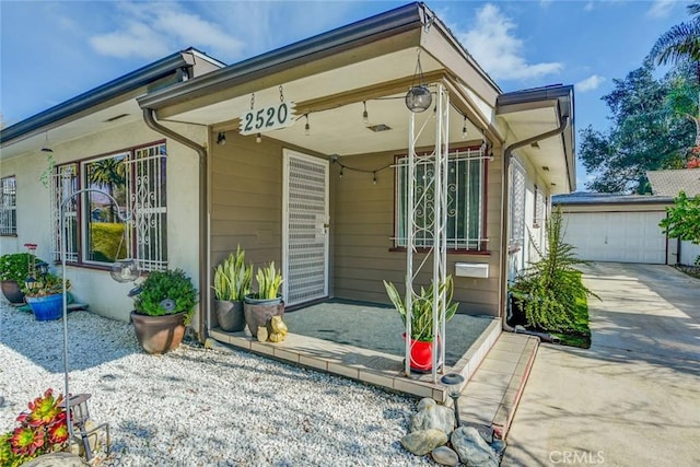 view of front of property with a garage and an outdoor structure