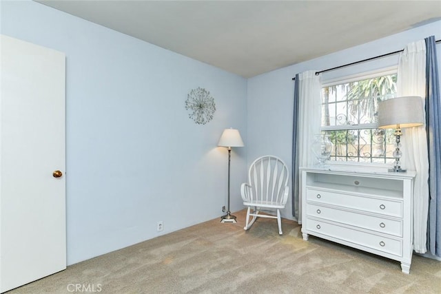 living area with light colored carpet