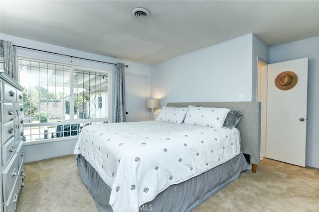 bedroom with light colored carpet